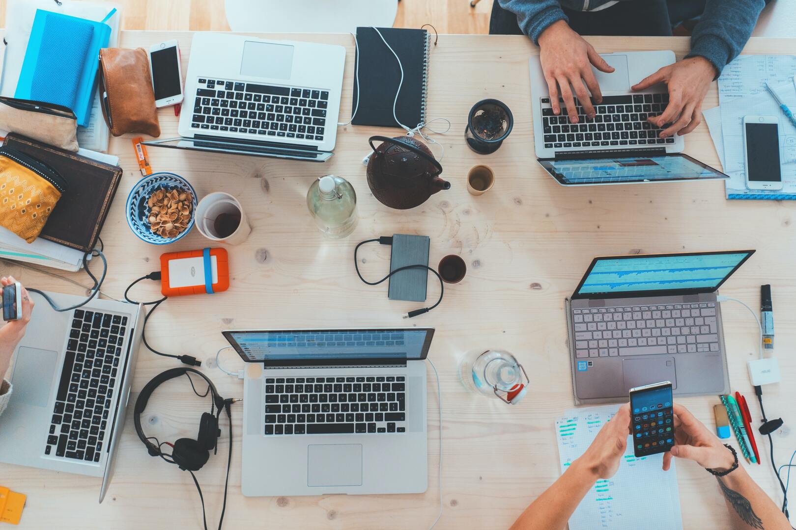 Picture of multiple people working digitally seen from above